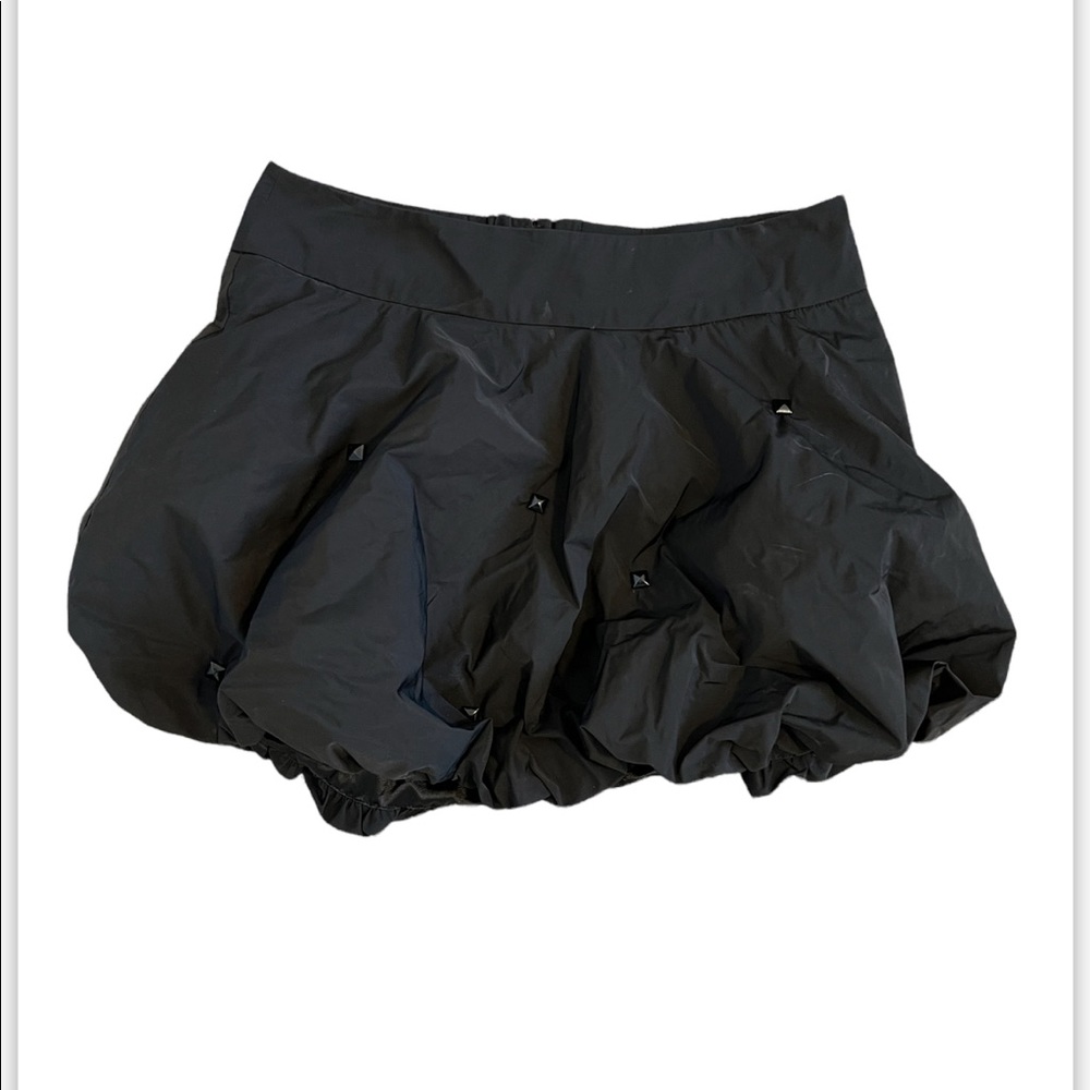 Black mini skirt with bunched detail.